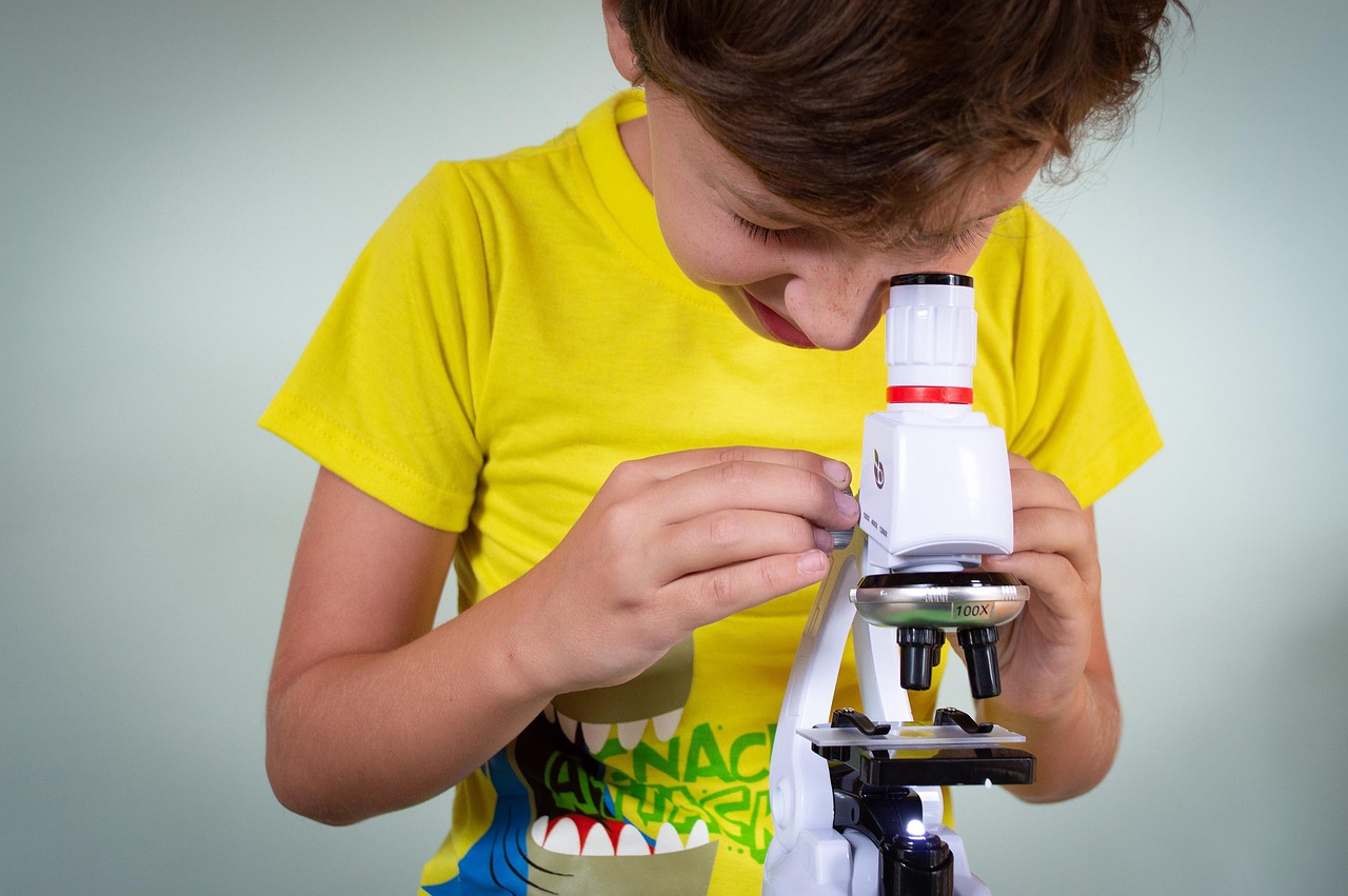 Boy looking at microscope